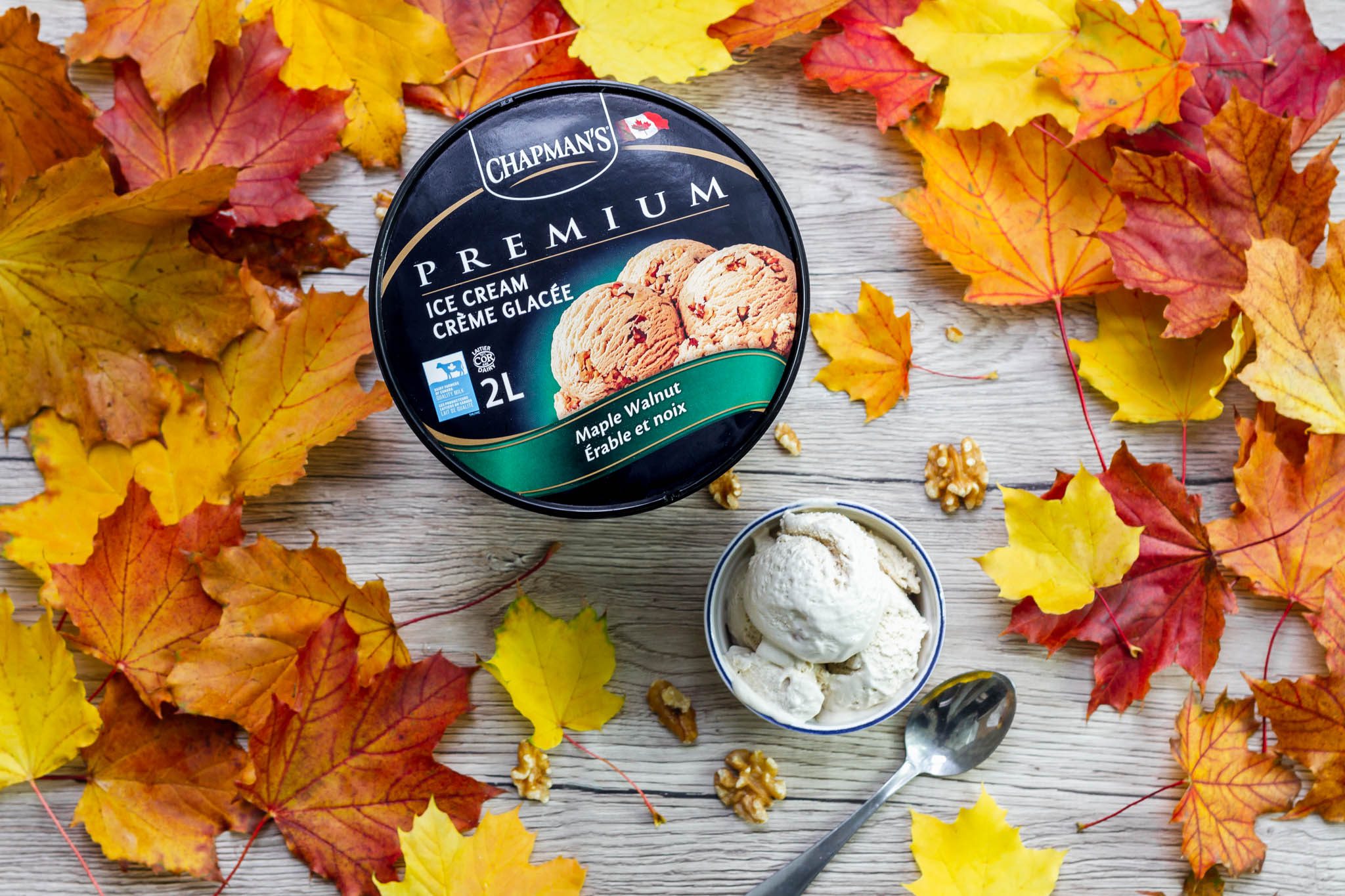 Chapman's Maple Walnut ice cream with maple leafs surrounding the tub