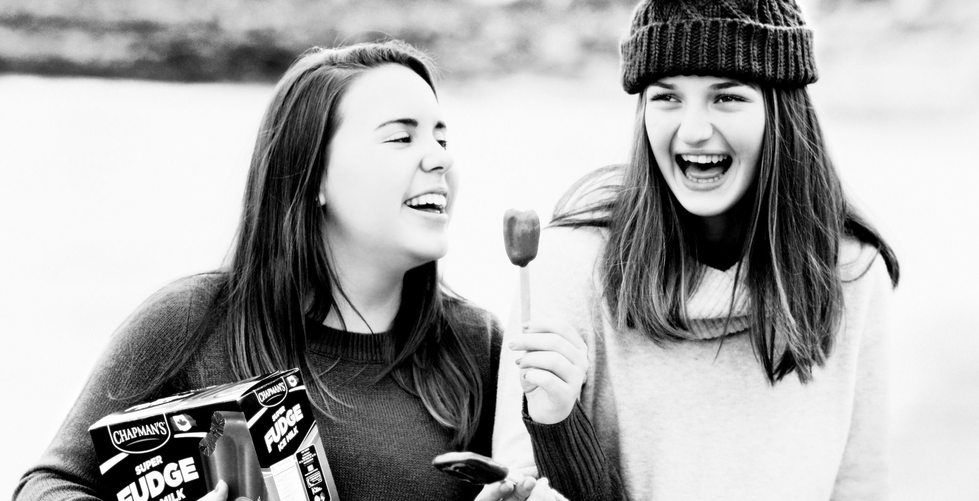 Two girls having a blast while eating Chapman's Fudge bar