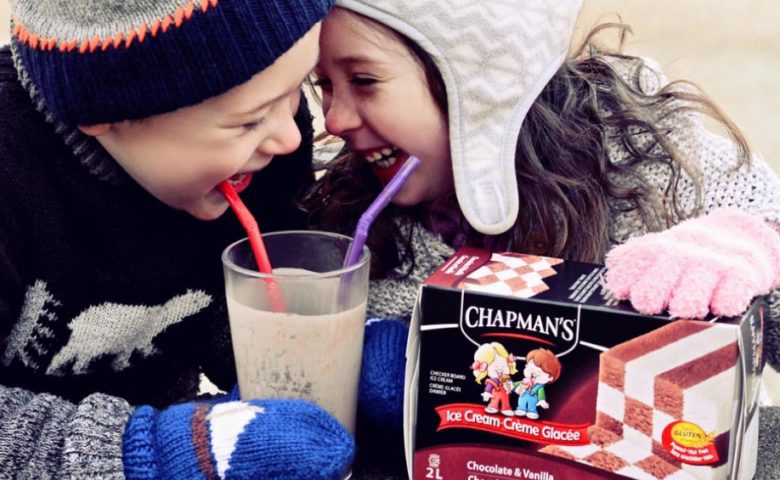 Boy and girl smiling and enjoying a milkshake made with Chapman's Chocolate & Vanilla Checkerboard Ice Cream