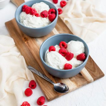 Chapmans lactose free ice cream scooped in to bowls with raspberries