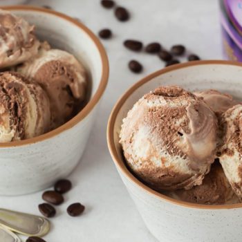 Chapmans lactose free ice cream scooped in to bowls with raspberries