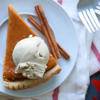 a slice of Pumpkin Pie topped with a scoop of Chapman's Ice Cream