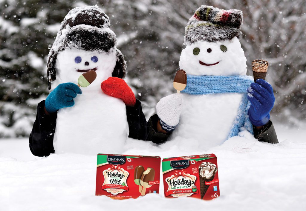 Two smiling snowmen with knitted mittens and hats holding Chapman's Holiday Moments Ice Cream Bars and Winter Cocoa ice cream cone