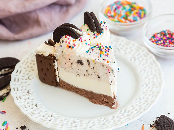 A slice of The Ultimate Chapman's Ice Cream Cake on a decorative white plate