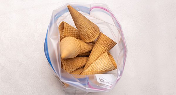 An open zip top bag with sugar cones inside
