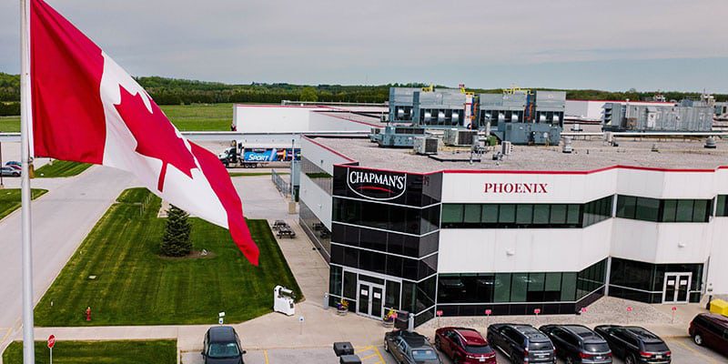 An outside aerial view of the front of Chapman's Phoenix building. A Canada flag flies on the left hand side.