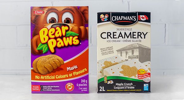 On a white marble kitchen counter is a box of Bear Paws Maple cookies and a carton of Chapman's Maple Crunch ice cream side by side.