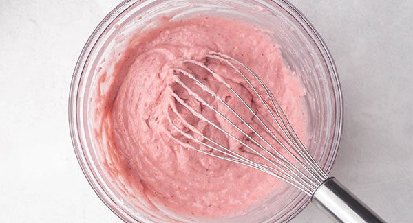 After mixing the ingredients in the glass bowl there is a  pink batter